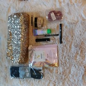 Gold Victoria's secret bag filled with a variety of beauty products.